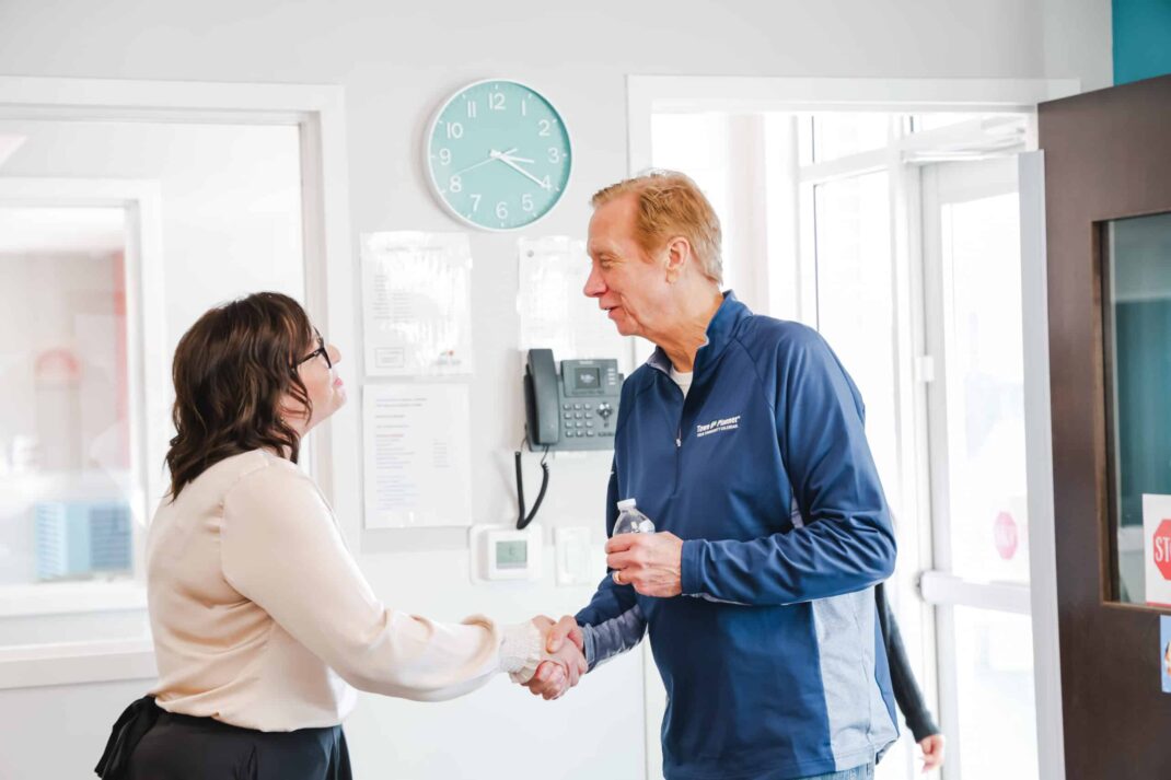two people shaking hands in a greeting.
