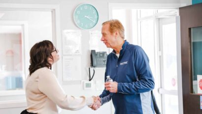 two people shaking hands in a greeting.