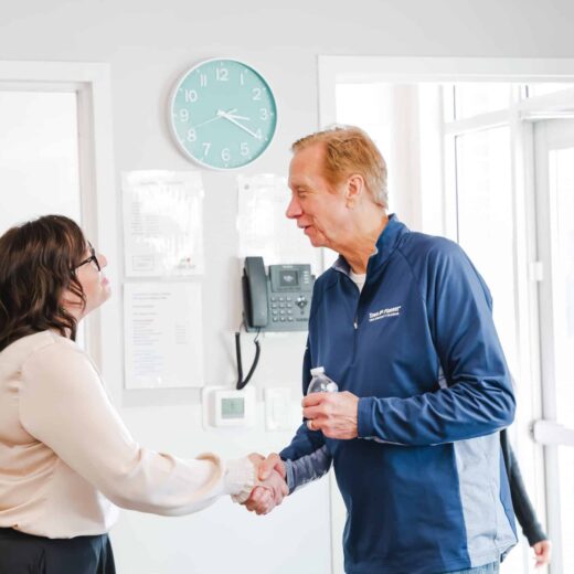 two people shaking hands in a greeting.