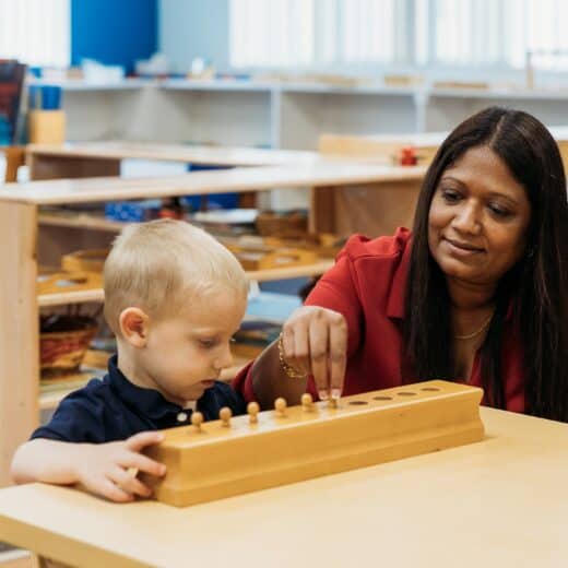 Woman teaching little boy how to play a game.